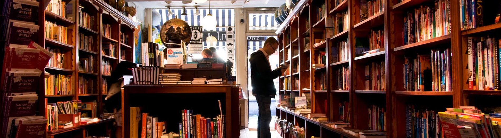 A person reading a book in the book shoppe